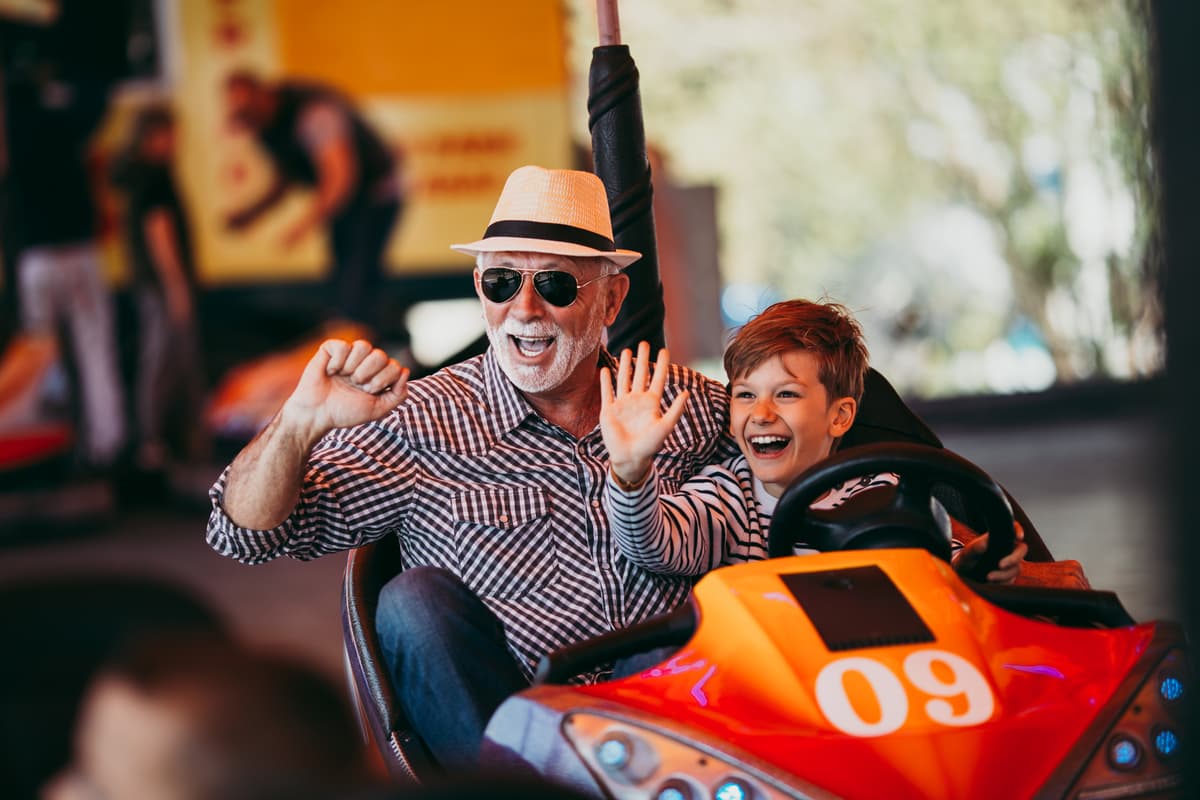 Grandfather and grandchild at amusement park
